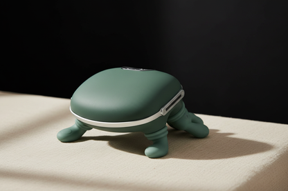 Portable Finger Press Massager on a beige surface against a dark background.